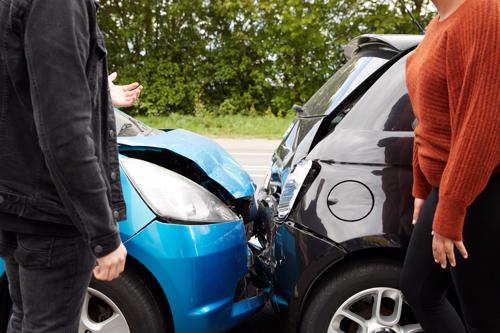 Two drivers discussing a rear-end car accident.