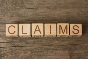 CLAIMS word in vintage wooden blocks