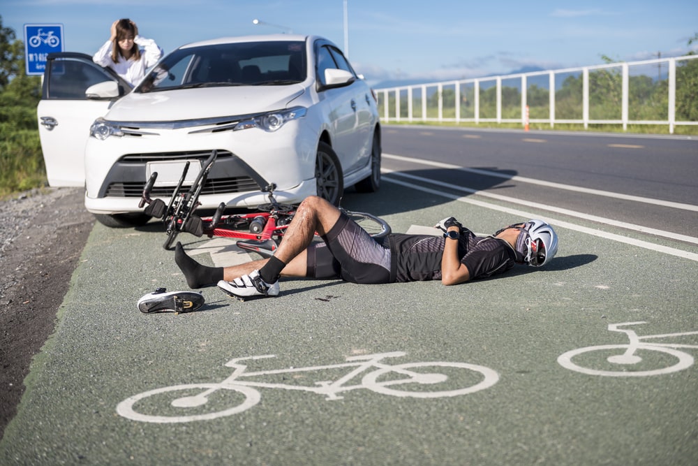 Cyclist Laying on the Street After Getting Hit From a Car