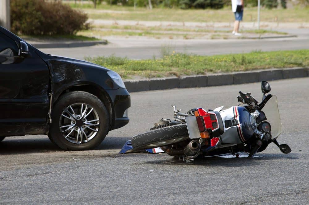 Motorcycle Laying on the Street After Accident with Car