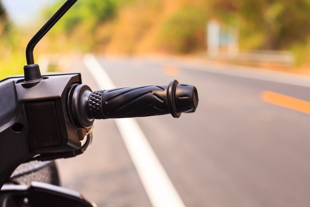 Motorcycle Handle With the Road In the Background