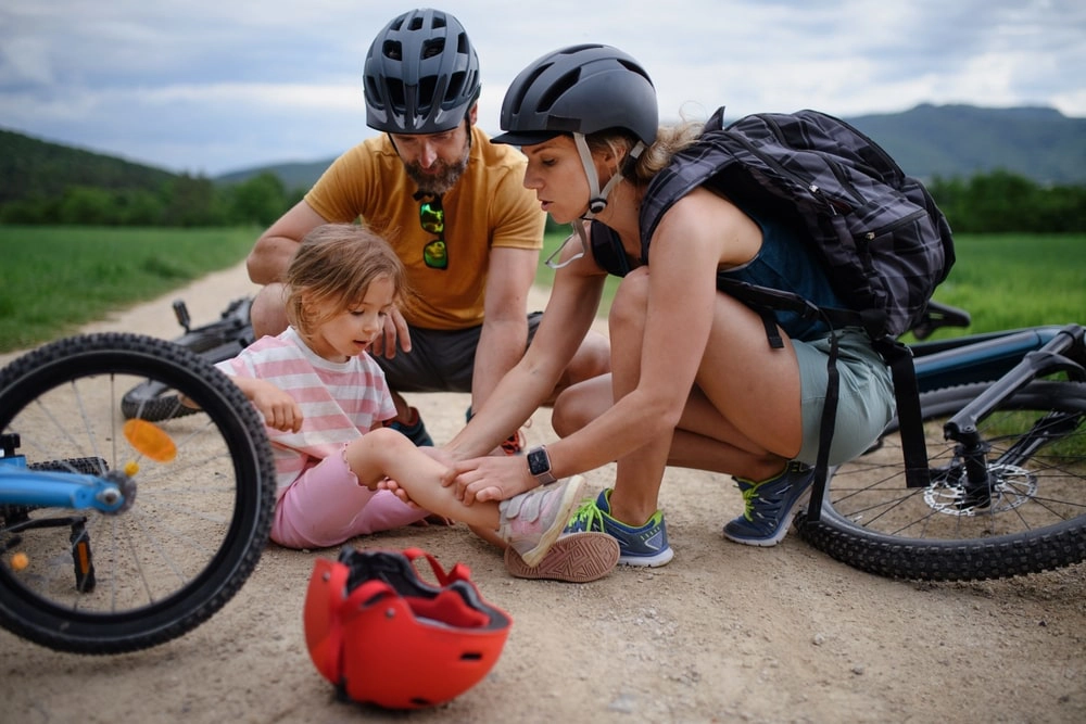 Child Leg Injury Parents Looking After Their Child Who Fells Of A Bike